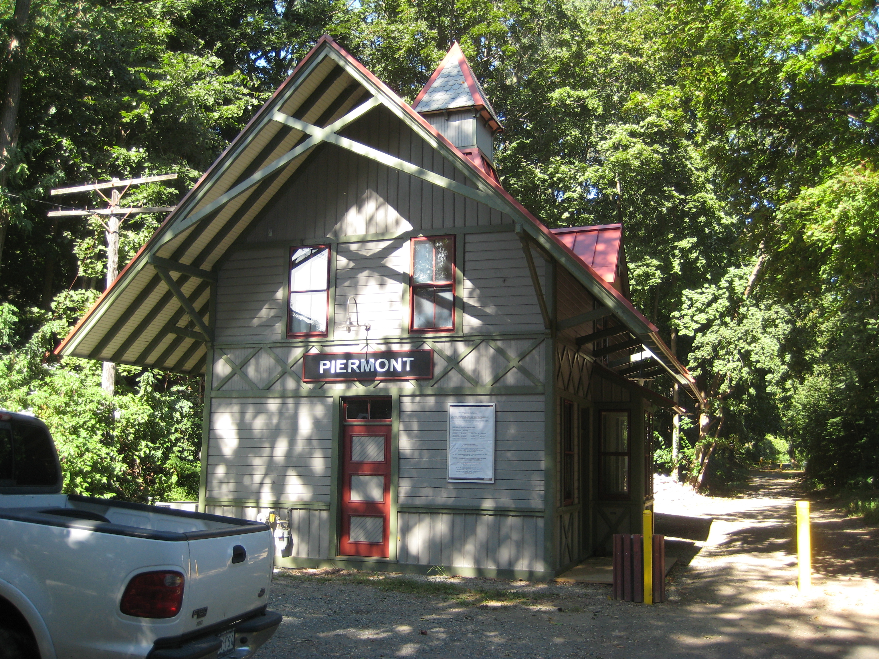 Historic Piermont railroad station beneath leafy trees